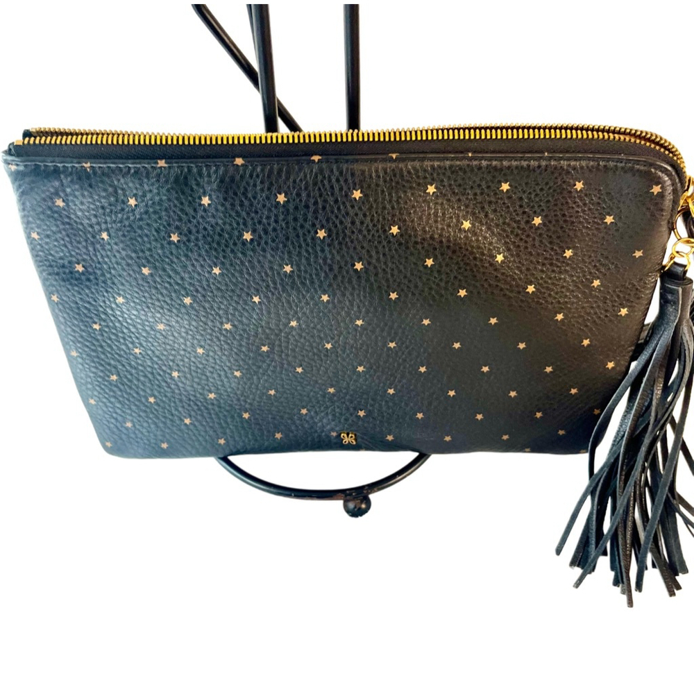 Hobo Wayfare wristlet in black pebbled leather with gold stars